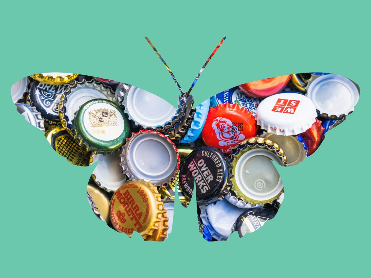 A butterfly shape, filled with dozens of colorful beer bottle caps, on a green background