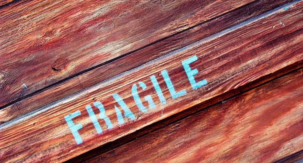 "Fragile" stenciled onto wooden box