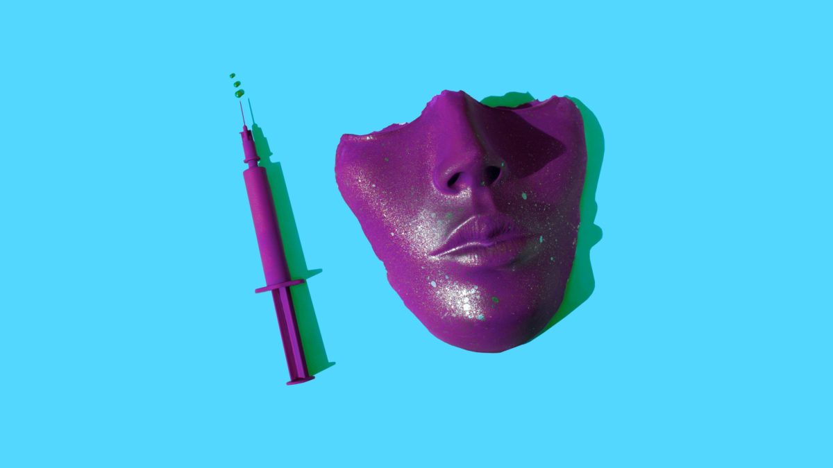 Half a plaster mask of a human face and a syringe — both magenta — sit against a bright blue background